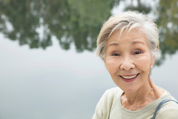 Portrait of senior woman beside lake