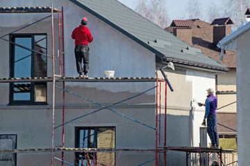 close up details of painting walls, industrial worker using roller and other tools for painting...