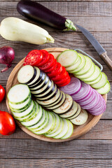 Step by step cooking Ratatouille. Ratatouille casserole on a wooden table. Provencal vegetable...