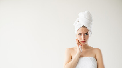 facial care. Disappointed woman. Rejuvenation treatment. Advertising background. Pretty unsatisfied lady touching face isolated white copy space.