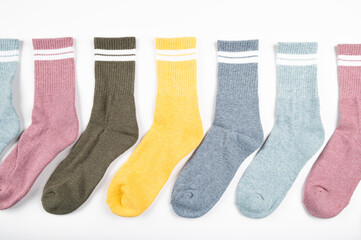 Multi colored women's socks with stripes isolated on white, top view
