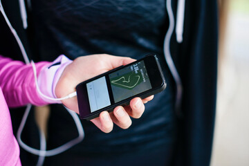 Close up of young womans hand selecting smartphone music