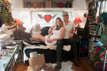 Portrait of couple in converted boutique airstream trailer