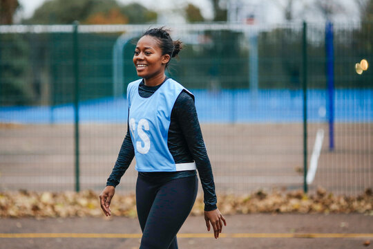 Young female netball player on netball court