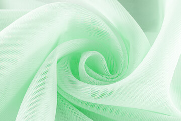 light green neoprene fabric rolled into a spiral