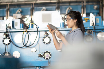 Technician operating machine in factory