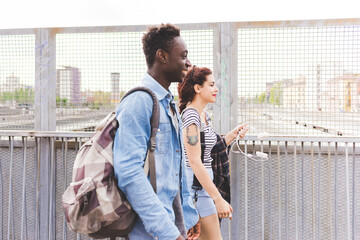 Couple walking in urban area smiling, Milan, Italy