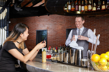 Woman in bar talking with bartender