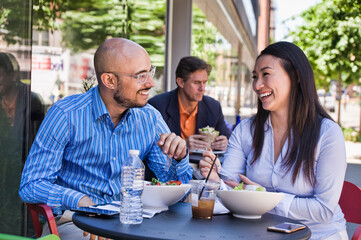 Man and woman having lunch outside cafe
