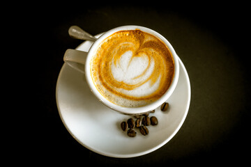 coffee cup and beans on a dark background