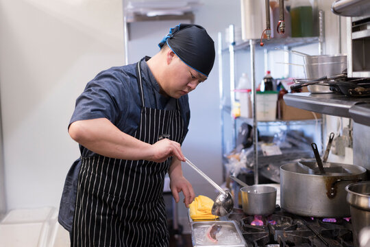 Chef in kitchen preparing food