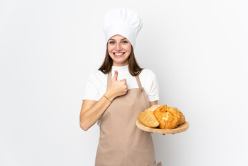 Young woman in chef uniform isolated on white background giving a thumbs up gesture