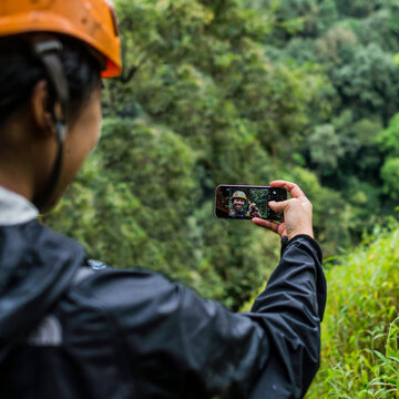 View over shoulder of hiker taking selfie, Ban Nongluang, Champassak province, Paksong, Laos