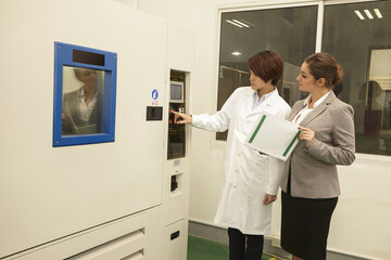 Technician showing manager printing machine in printing and packaging factory, China
