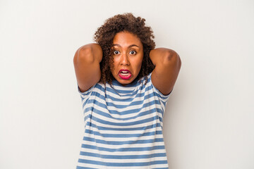 Young african american woman with curly hair isolated on white background screaming with rage.