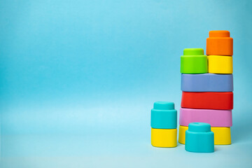 Colorful rubber toy blocks for babies stacked, copy space 