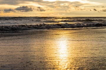 Sun reflection on the sea beach with the shallow focus in the evening