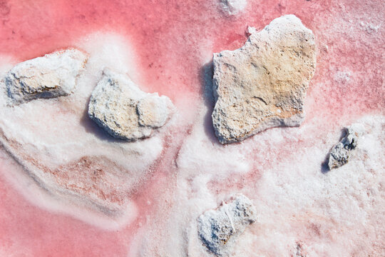 Pink lake beautiful white salt crystals on pink water background nice background. Crystal of mineral salt. Heap of salt.