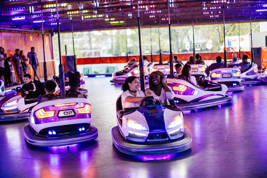 Group of friends at funfair, driving bumper cars