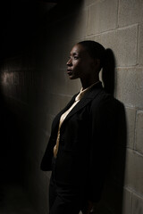 Businesswoman leaning on wall