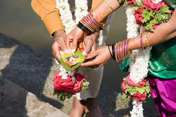 Couple holding puja in indian wedding ceremony