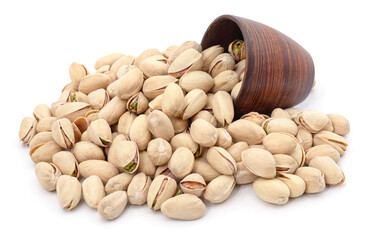 Pistachios in a bowl and around.