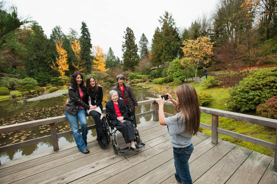 Girl photographing multi generation family