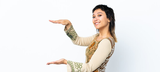Young Uruguayan girl over isolated white background holding copyspace to insert an ad