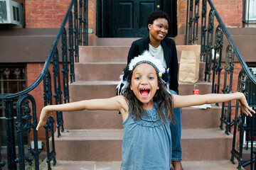 Girl smiling at camera with outstretched arms