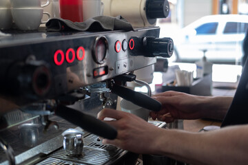 Fototapeta na wymiar Barista faceless make coffee latte art with espresso machine in cafe