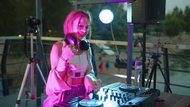 beautiful dj woman playing music at glamorous party celebration dance enjoying fancy social event wearing stylish fashion dancing performing live in club at night 4k footage.