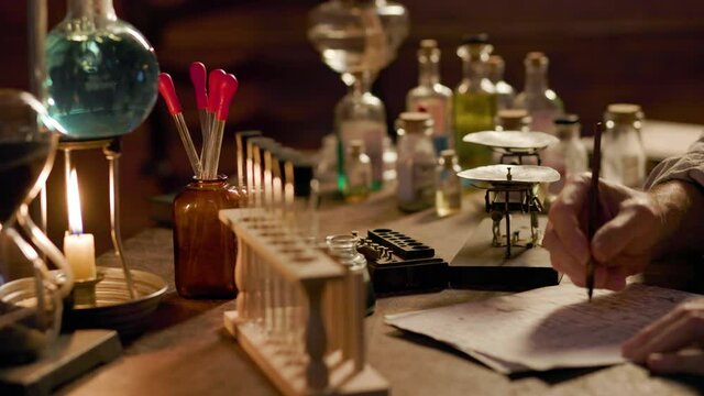 A 19th century apothecary or chemist in his laboratory using a dip pen to document his findings and formulas.
