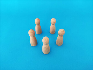 Teamwork and cooperation concept, people stand in a circle on a blue background