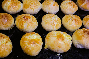 Homemade traditional  pastries on baking tray. Traditional Russian pastries Vatrushka.Round and appetizing homemade pies baked  with a nice tan color