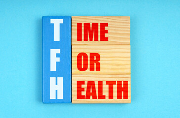 On a blue background, wooden plaques with the inscription - TIME FOR HEALTH