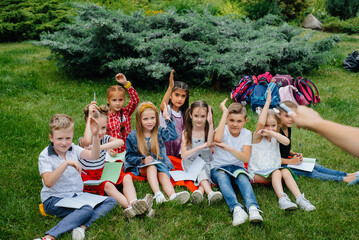 A teacher teaches a class of children in an outdoor Park. Back to school, learning during the pandemic