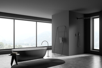 Shower cabin with narrow window in dark grey panoramic bathroom. Corner view.