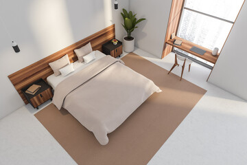 Top view of a bed in a modern white hotel bedroom