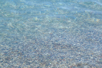 Colorful pebbles under the clear sea.Desktop background.