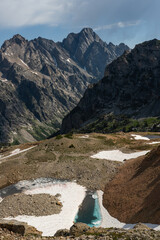 Small Frozen Pond Below Trail Looking Over Jagged Cliffs