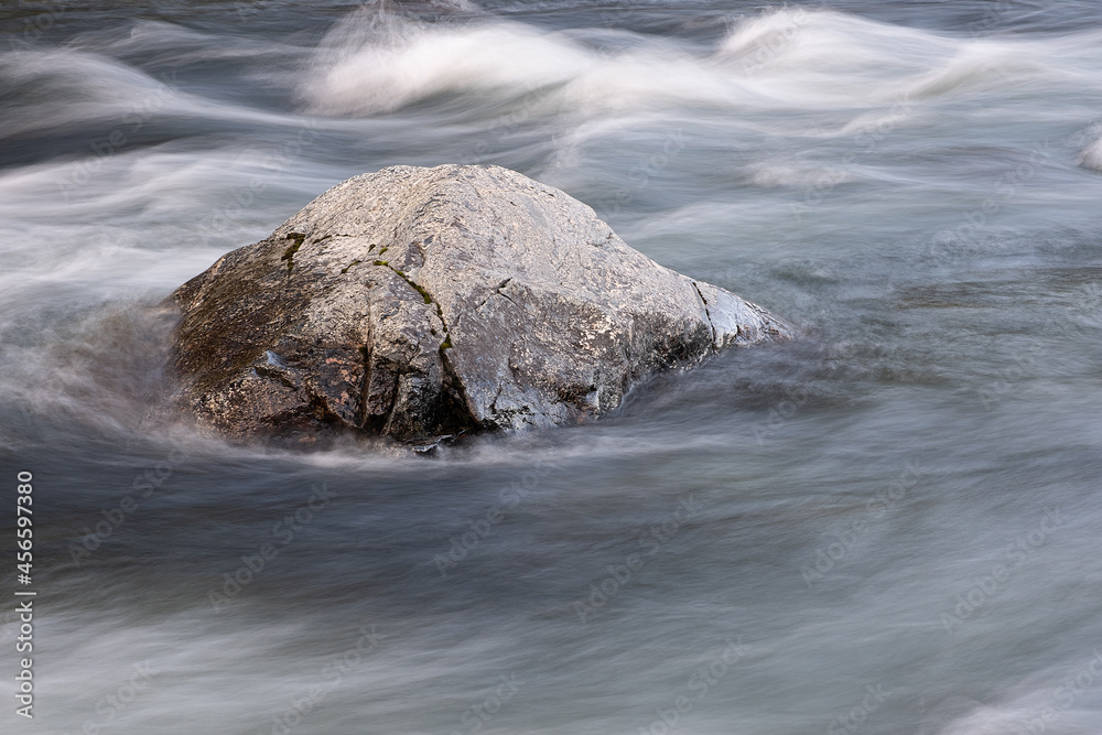 Poster abstract background from long exposure of water stream in a mountain river close-up