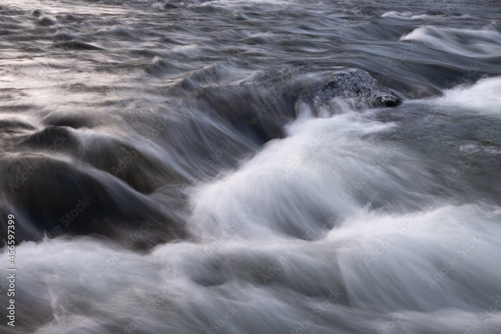 Poster abstract background from long exposure of water stream in a mountain river close-up