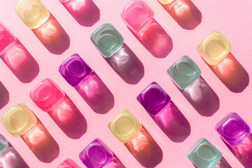 Creative layout with colorful plastic cubes of ice at midday sun and hard shadows at the background. Summer mockup. Flat lay. Copy space.