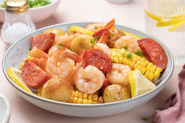 Shrimp boil heap with corn, baby potatoes, sausage and lemons.