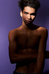 Fototapeta premium Portrait of young african american man standing in casual pose and looking camera. Transgender model
