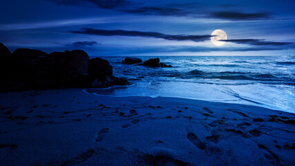 huge stones on the sandy beach at night. wonderful velvet season vacation on the black sea in full...