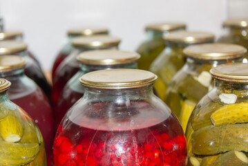 Jars of cucumbers and juice, supplies for the winter.