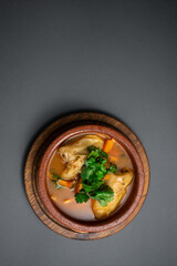 closeup of stuffed bell pepper with rice and meat stewed in tomato sauce in bowl