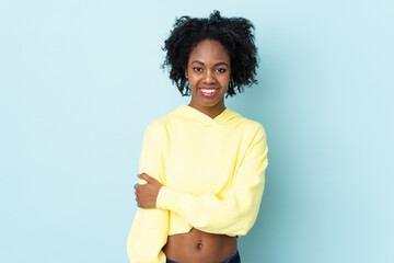 Young African American woman isolated on blue background laughing