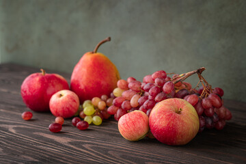 Background with apples, grape, pear at the wooden table